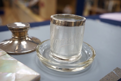 A 1930's cased silver christening trio, a silver mounted inkwell, a silver pepperette, a silver mounted glass match strike/ashtray and a mother of pearl card case.